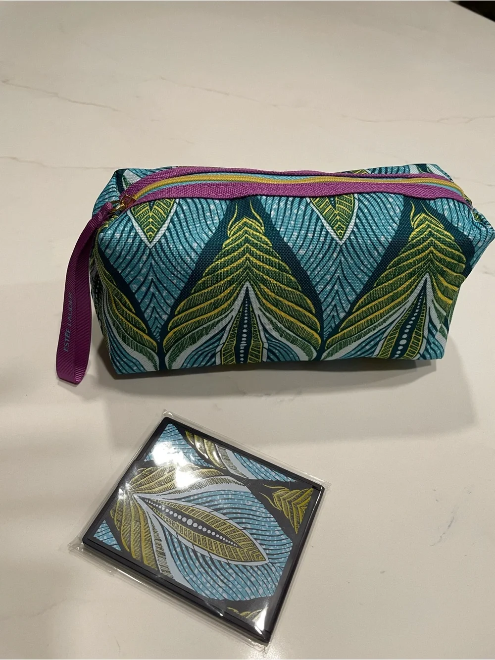 Estée Lauder Blue & Green Leaf-Print Cosmetic Pouch with matching pocket mirror.
